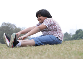 Child stretching in park (World Obesity image).PNG