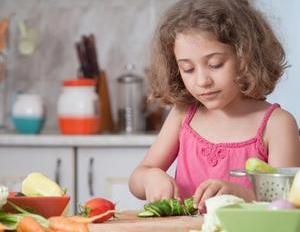 Little girl chopping vegetables.jpg