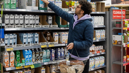 Man buying Oatly products in supermarket.jpg