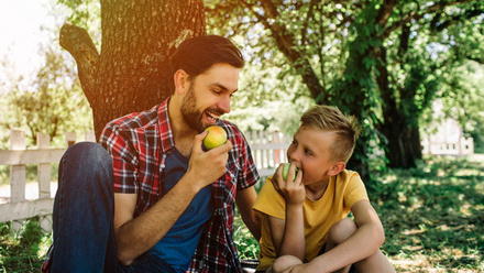 man_and_boy_eating_apple.jpg