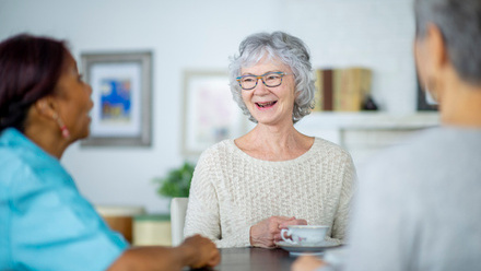 Senior older woman talking with friends