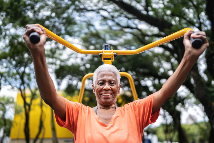 Portrait of a senior woman exercising in the park - stock photo
