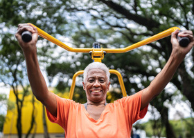Portrait of a senior woman exercising in the park - stock photo