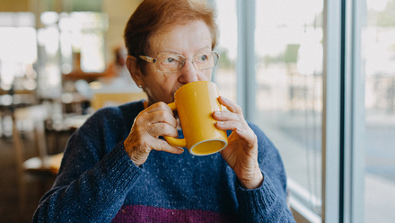 Older Woman Sipping Hot Drink Tea Coffee
