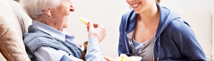 older_person_dietitian_smiling_eating_home.jpg