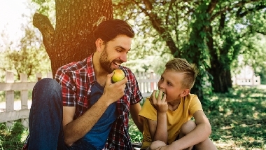 man_and_boy_eating_apple.jpg